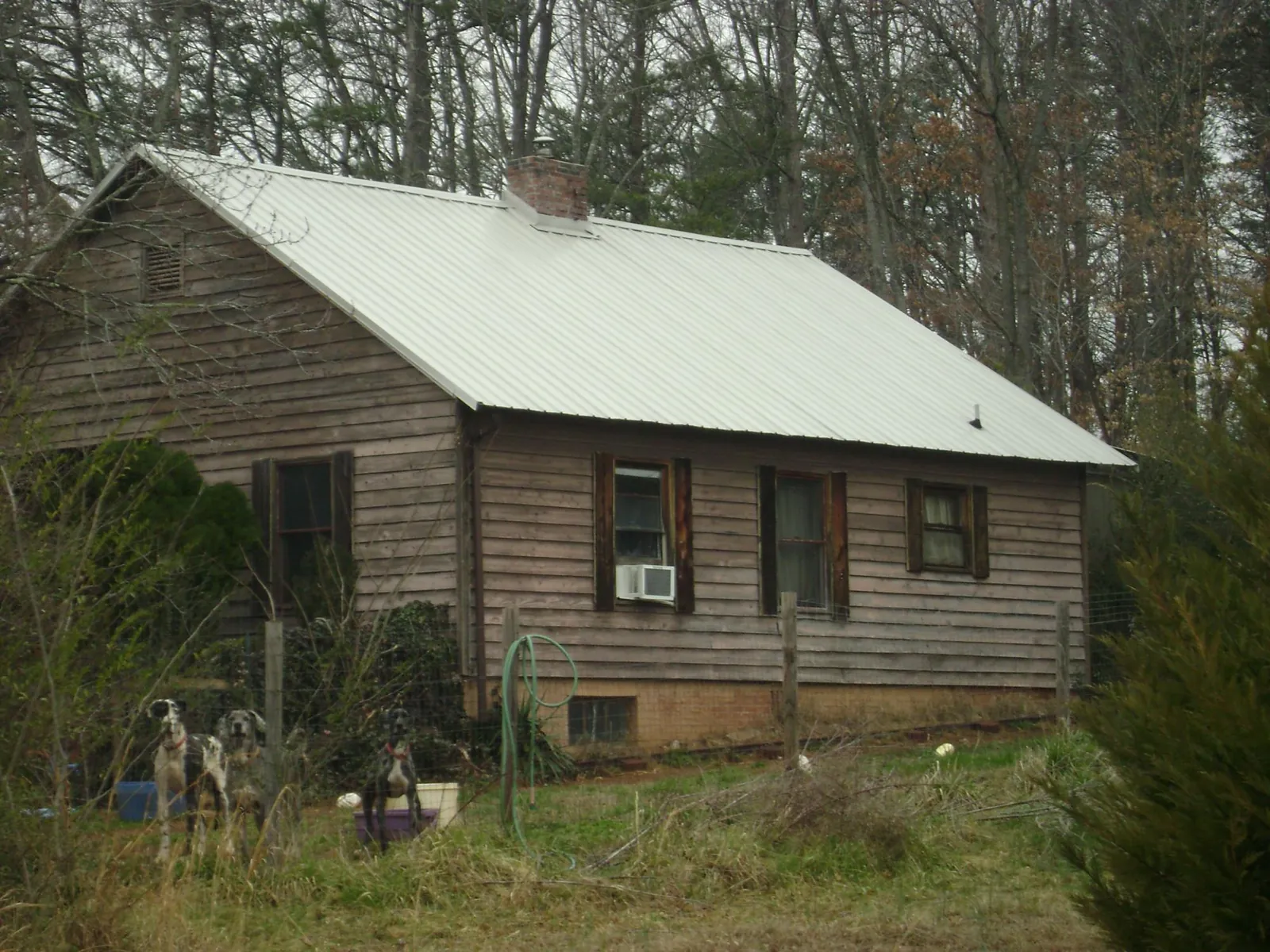 White metal roof on an old wood sided farmhouse, from a Metal Roof Installation job in Revere